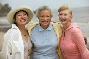 Portrait of cheerful female friends enjoying vacation at beach